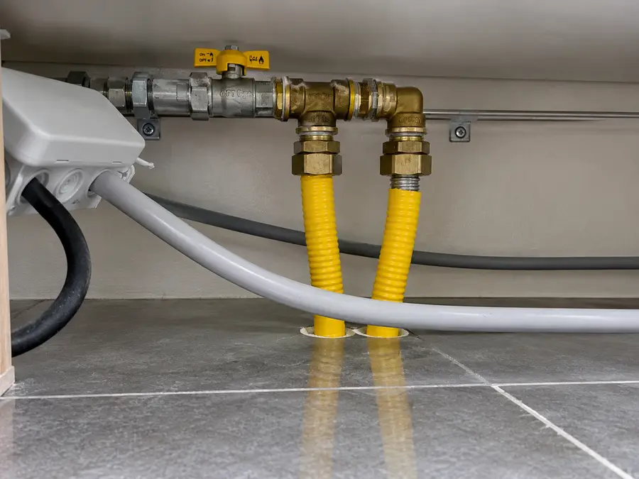 Nieuw aangelegde gasleiding met gaskraan en gele flexibele leidingen